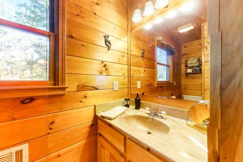 a bathroom with a sink and a mirror at River's Creekside Cabin in Ellijay