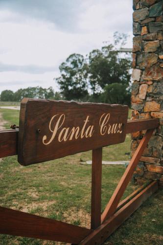 a sign for a jamaica club sitting in a field at Estancia Santa Cruz in José Ignacio