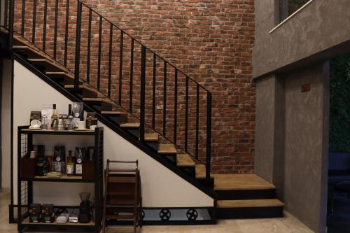 a staircase in a building with a brick wall at Dab Hotel Ulus in Ankara
