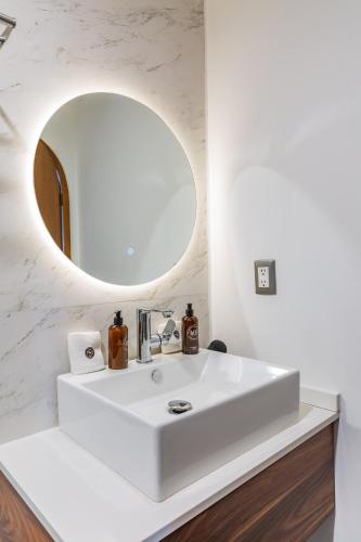 a bathroom with a white sink and a mirror at Casa Castillo in Mexico City