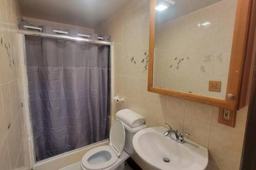 a bathroom with a toilet and a sink and a shower at Entire 4 bedroom house - Enfield in Enfield