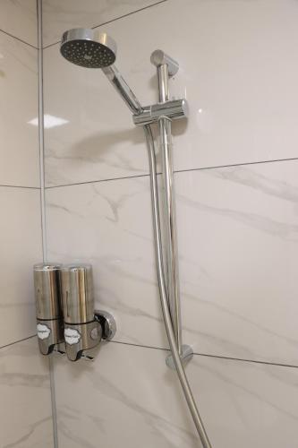 a shower in a bathroom with a shower head at Dab Hotel Ulus in Ankara