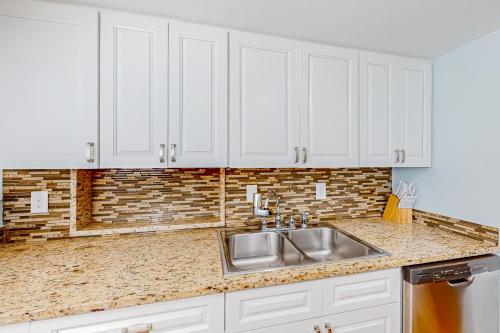 a kitchen with white cabinets and a sink at Seascape Villas, Unit 3239 in Hilton Head Island