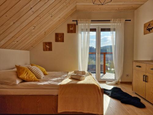 Katil atau katil-katil dalam bilik di Nad Zalew dom z basenem letnim, jacuzzi i sauną, jezioro i trasa Velo Czorsztyn w pobliżu