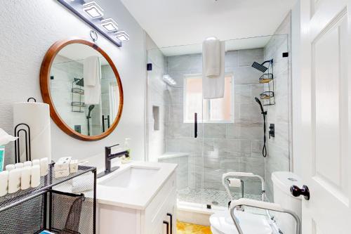 a white bathroom with a sink and a mirror at Isabella Duplex - A in Houston