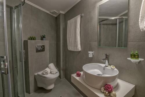 a bathroom with a sink and a toilet and a shower at Aloe Apartments in Rethymno Town