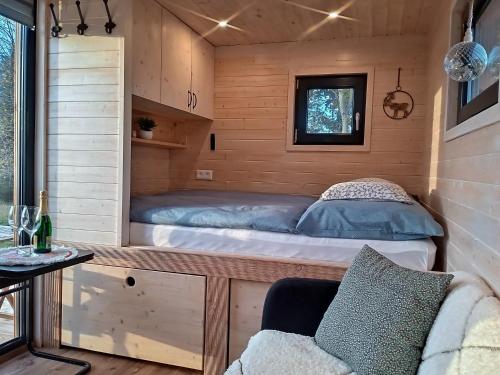 a bed in a tiny house at Maringotka_naluke in Detvianska Huta