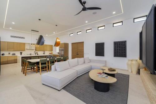 a living room with a white couch and a table at Casa Herradura - Ocean View Luxury Villa in Cabo San Lucas