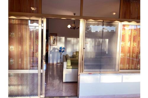 uma sala de estar com portas de vidro deslizantes e um sofá em Armand’s apartament em Golem