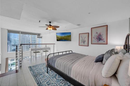 a bedroom with a large bed and a balcony at Iconic 1BR loft Brickell-Waterviews in Miami