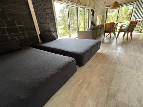 a bedroom with two beds and a table and chairs at Tiny Camp House Kurage - Vacation STAY 66334v in Kamijinoo