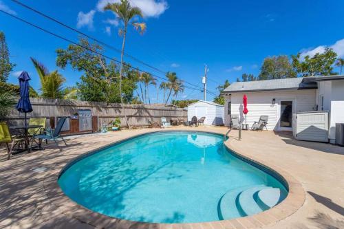 a swimming pool in the backyard of a house at Beach House/KING BD/Hot Tub/Pool/Fire Pit/Gym/Golf in Lantana