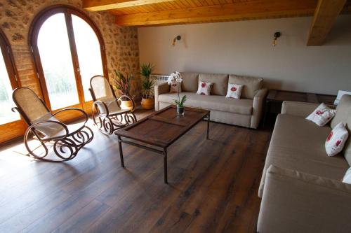 a living room with a couch and a table at La Creu de la Pinya in Berga