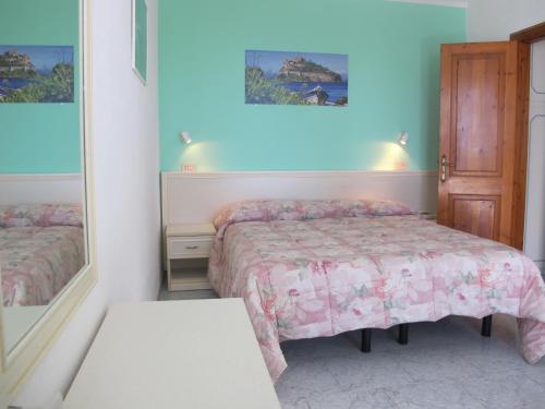 a bedroom with two beds and a mirror at Aparthotel Villa Marinù in Ischia