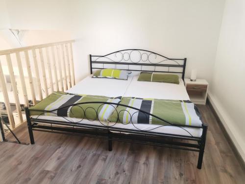 a bed with a black frame in a bedroom at Eifel Farmhouse Retreat in Auw