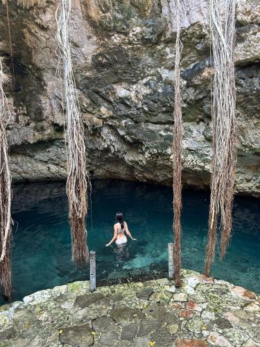 a woman in a pool of water in a cave at Hameki in Homún