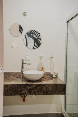 a bathroom counter with a sink and mirrors on the wall at a 5 min de la playa alberca privada by G P S rentas in Mazatlán