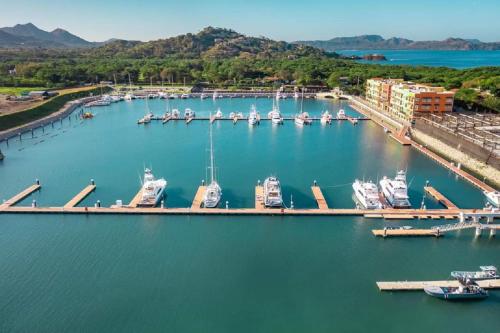 an aerial view of a marina with boats docked at 360 Splendor - Ocean-View Condo #204 in Luxury Flamingo-Complex in Playa Flamingo