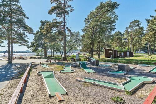 a playground with green slides in a park at Hytte på sørlandet in Kristiansand