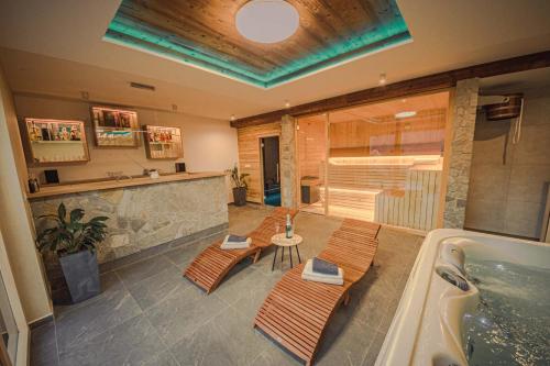 a bathroom with two benches and a bath tub at ZORE JASNÁ Apartments in Demanovska Dolina