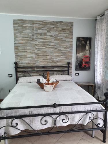 a bedroom with a large bed with a brick wall at B e B House in Castellanza