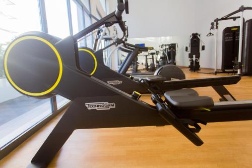a gym with a treadmill and a simulator at Accra Luxury Apartments @ The Signature in Accra