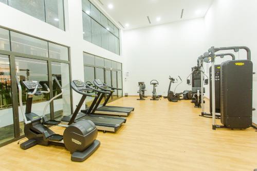 a gym with several treadmills and machines in a room at Accra Luxury Apartments @ The Signature in Accra