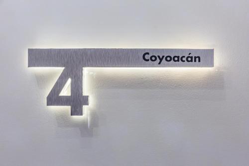 a sign for a door with the name of a company at Casa Castillo in Mexico City
