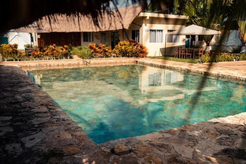 a swimming pool in front of a house at Hameki in Homún
