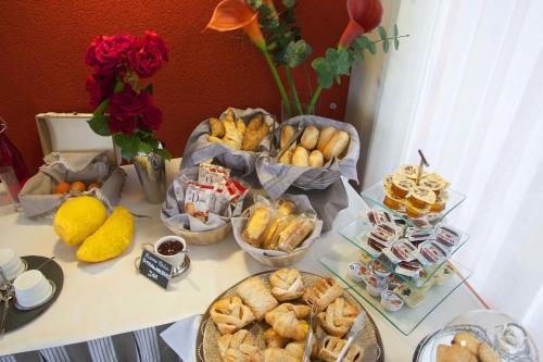 a table filled with different types of pastries and desserts at B&B Il Parco in Monterosso al Mare