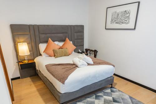 a bedroom with a large bed with orange pillows at Casa Castillo in Mexico City