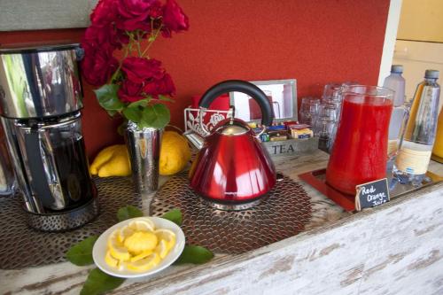 a counter topped with a counter top with a red appliance at B&B Il Parco in Monterosso al Mare