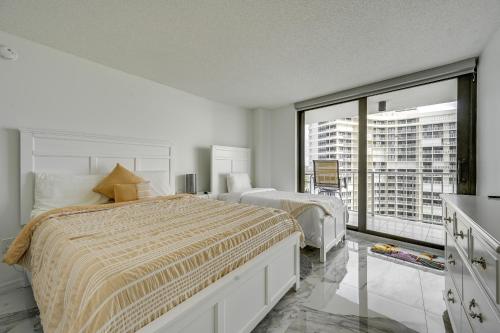 a bedroom with two beds and a large window at Beachfront Marco Island Condo with Pool Access! in Marco Island
