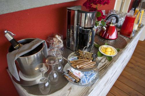 a counter top with wine glasses and a coffee maker at B&B Il Parco in Monterosso al Mare