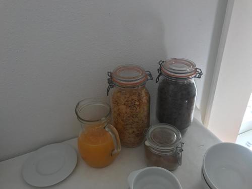 three jars of food sitting on a shelf in a refrigerator at Monte das Texugueiras in Texugueira