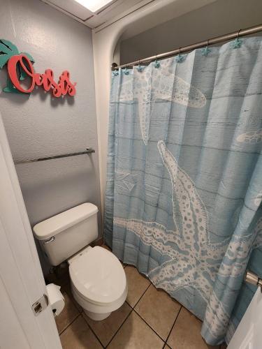 a bathroom with a toilet and a shower curtain at Heated Pools, Heated lazy river, 3 hot tubs-Privately owned Oceanfront renovated condo on 12th floor in Myrtle Beach