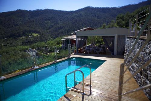 a swimming pool with a view of a mountain at B&B Il Parco in Monterosso al Mare