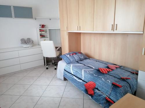 a bedroom with a bed with red hearts on it at Il Piacere di Casa - Appartamento a Porto Viro in Porto Viro
