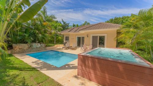 a swimming pool in front of a house at 2 Bed, 2 Bath, New Jacuzzi, High Speed Wi-Fi in Sosúa