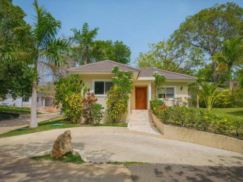 a white house with a driveway at 2 Bed 2 Bath Villa with Jacuzzi, High Speed Wi-Fi in Sosúa