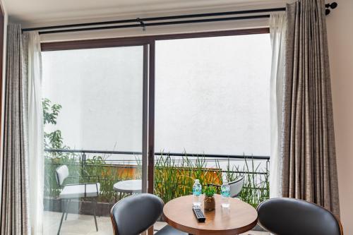 a room with a table and chairs and a large window at Casa Castillo in Mexico City