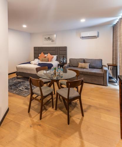 a living room with a bed and a table and chairs at Casa Castillo in Mexico City