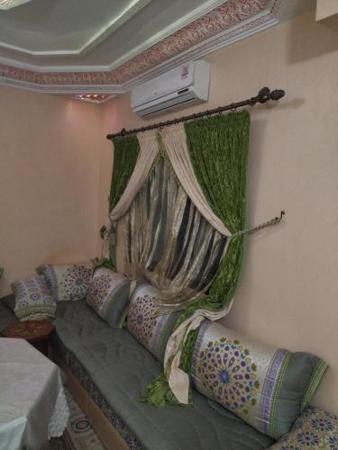 a room with a couch with a curtain and a heater at مراكش in Marrakesh