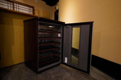 a wine cellar with a cabinet with wine bottles at HOTEL Lee in Tokyo
