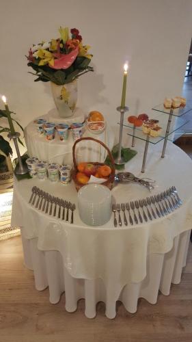 a table with a white table cloth with food on it at Hotel Bristol in Tarnów