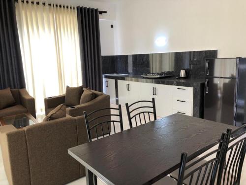 a kitchen and living room with a table and chairs at Luvi’s Villa in Galle