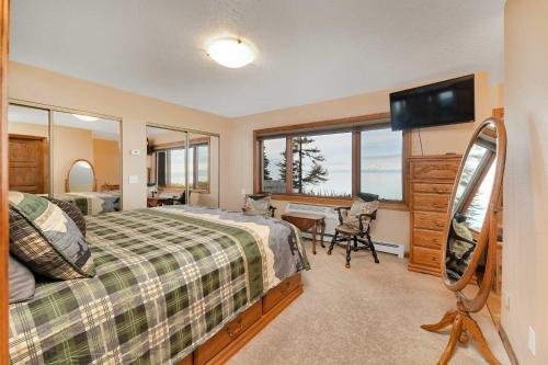 a bedroom with a bed and a desk and a television at Kenai Vacation Rental with Volcano and Glacier Views! in Kenai