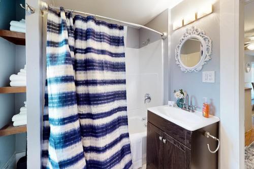 a bathroom with a sink and a shower curtain at Vermont Marble Haven - Unit 2 in Rutland