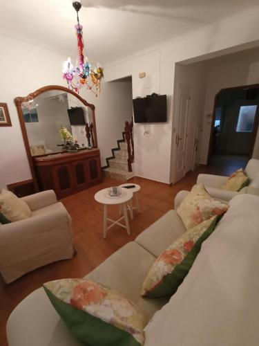 a living room with a couch and a mirror at Casa Jesús in Muxia