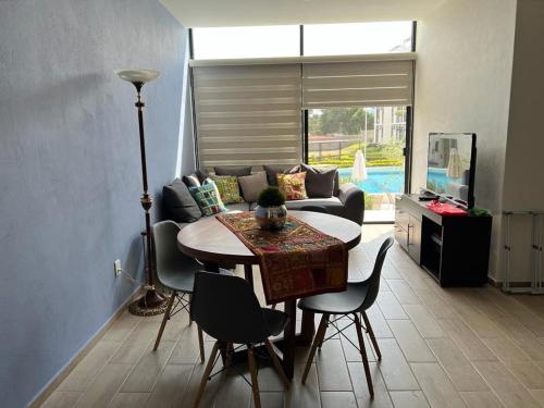 a living room with a table and a couch at RIBERA DE CHAPALA Suites in Chantepec